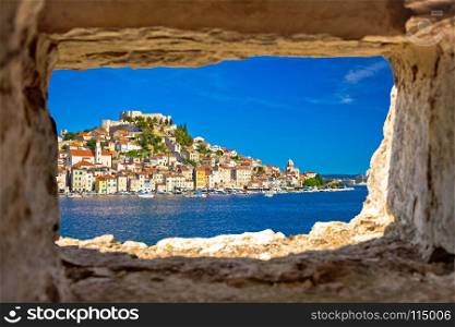 Historic town of Sibenik waterfront view through stone window, UNESCO world heritage site in Dalmatia, Croatia