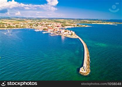 Historic town of Umag and harbor breakwater aerial view, archipelago of Istria, Croatia