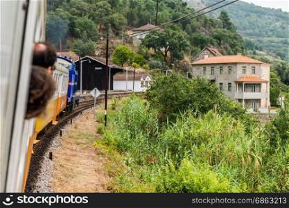 Historic train arriving to Mirao Train Station. The train runs between June and October along the bank of the river Douro.
