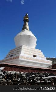 Historic white stupa in Tibet, against blue sky
