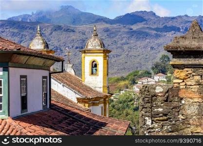 Historical baroque church with mountains in the background in Ouro Preto city in Minas Gerais. Historical colorful church with mountains