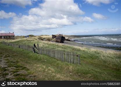 Historical building and shipwreck on the beach, Strait of Magellan, Estancia San Gregorio, Patagonia, Chile