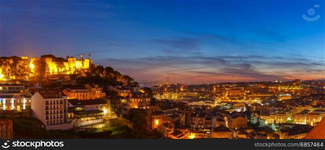 Historical centre of Lisbon at sunset, Portugal. Panorama with Castle of Sao Jorge, the historical centre of Lisbon, Tagus River and 25 de Abril Bridge during evening blue hour, Lisbon, Portugal