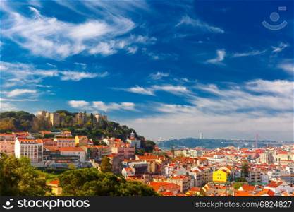 Historical centre of Lisbon on sunny day, Portugal. The Castle of Sao Jorge, the historical centre of Lisbon, Tagus River and 25 de Abril Bridge on the sunny afternoon, Lisbon, Portugal