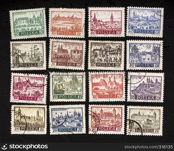 historical representation of famous Polish cities - a set of vintage caceled post stamps on black canvas