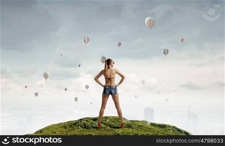 Hitch hiker woman on top. Young attractive girl in bikini and shorts on top