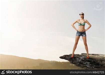 Hitch hiker woman on top. Young attractive girl in bikini and shorts on top