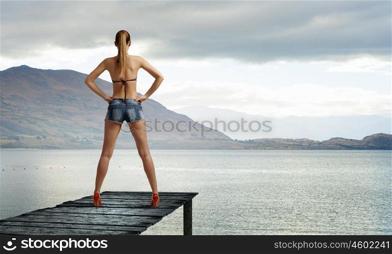 Hitch hiker woman. Young attractive girl in bikini and shorts on berth