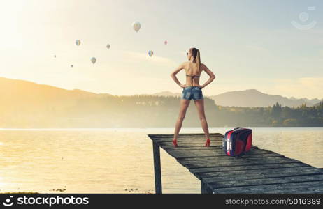 Hitch hiker woman. Young attractive girl in bikini and shorts on berth