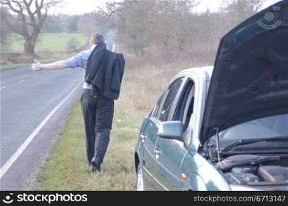 hitch hiking by broken down car