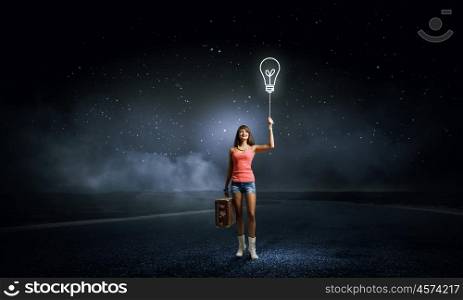 Hitch hiking traveling. Young retro woman with balloon and her vintage baggage in hand