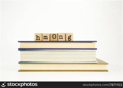hmong word on wood stamps stack on books, academic and language concept