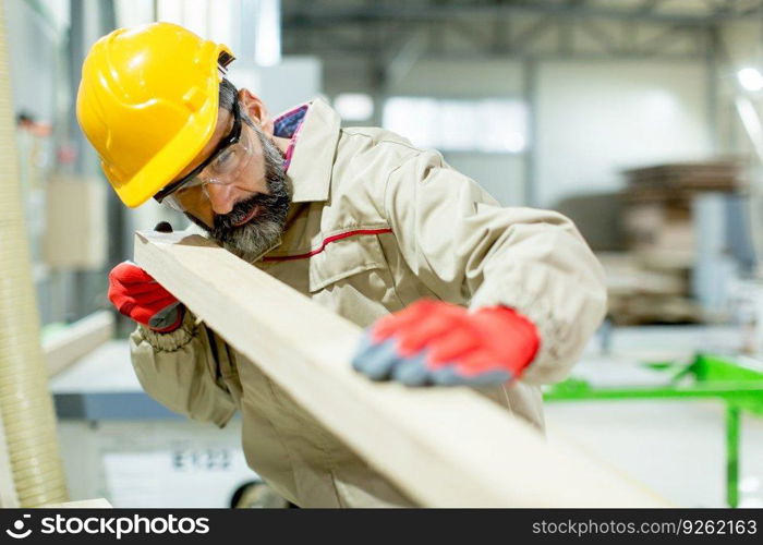 Hndsome middle aged worker working in the furniture factory