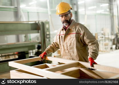 Hndsome middle aged worker working in the furniture factory