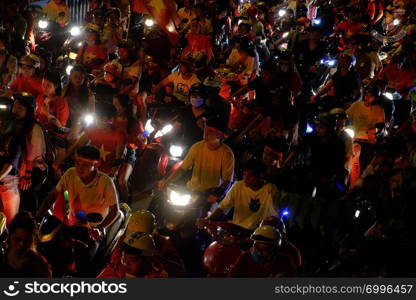 HO CHI MINH CITY, VIET NAM- DEC 15, 2018: Crowded Vietnamese street at night, young people ride motorbike stuck in traffic jam, motorcycles in slow moving at big city, amazing traffic from high view