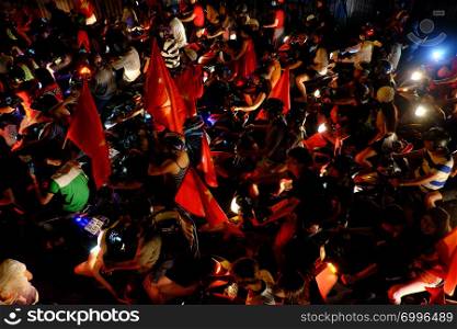 HO CHI MINH CITY, VIET NAM- DEC 15, 2018: Crowded Vietnamese street at night, young people ride motorbike stuck in traffic jam, motorcycles in slow moving at big city, amazing traffic from high view