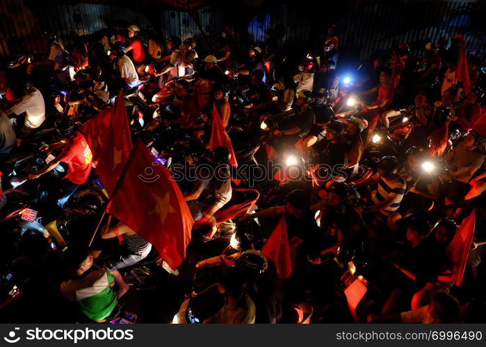 HO CHI MINH CITY, VIET NAM- DEC 15, 2018: Crowded Vietnamese street at night, young people ride motorbikes stuck in traffic jam, motorcycles in slow moving at big city, amazing traffic from high view