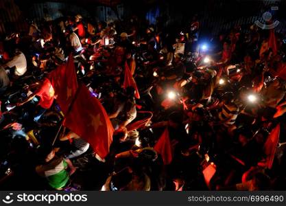 HO CHI MINH CITY, VIET NAM- DEC 15, 2018: Crowded Vietnamese street at night, young people ride motorbikes stuck in traffic jam, motorcycles in slow moving at big city, amazing traffic from high view