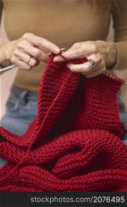 hobbies and leisure. girl knits a red scarf