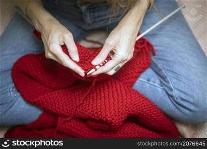 hobbies and leisure. girl knits a red scarf