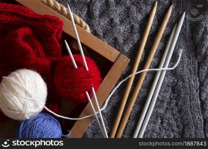 hobby. knitting - balls threads and knitting needles on a knitted fabric