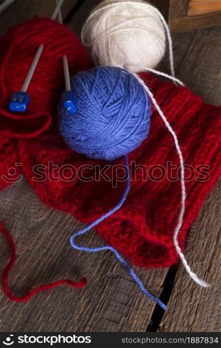 hobby. knitting - set of multicolored balls threads and knitting needles on a wooden table