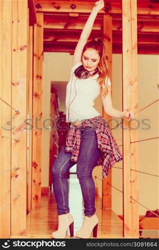 Hobby music expression and free time. Young girl listen music on phone dance indoors have fun hand gesture.. Woman with headphones listen music and dance.
