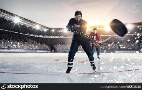 Hockey match at rink mixed media. Hockey players shoot the puck and attacks