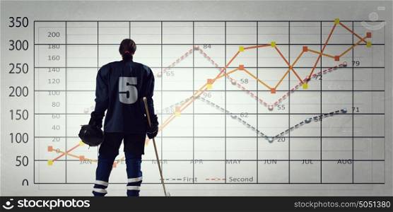 Hockey player and dynamics graph. Ice hockey player and graphs at background