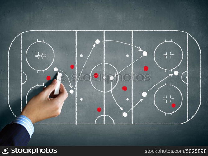 Hockey strategy plan. Close up image of human hand drawing hockey tactic plan