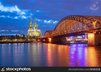 Hohenzollern Bridge with Cologne Cathedral at night in Cologne city, Germany.