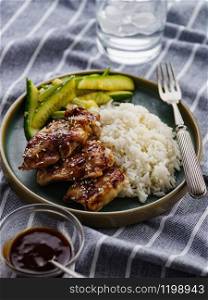 Hoisin Chicken. Traditional Asian cuisine. Chicken with sauce, rice and pickled cucumbers