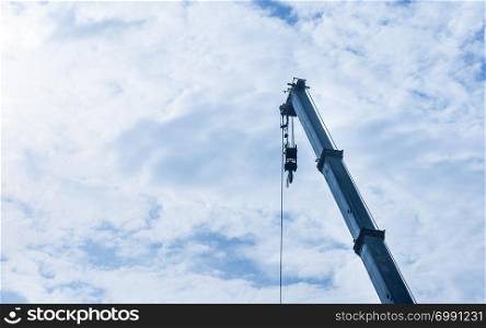 hoist crane hook head with blue sky cloud background