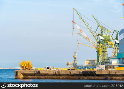 Hoisting cranes in the industrial zone of the Port in Kobe Hyogo Kansai Japan using for import export shipping and global business background