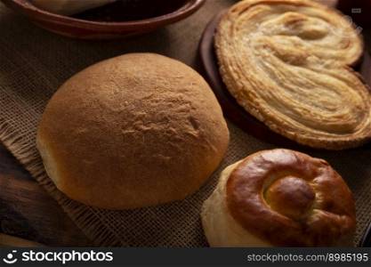 Hojaldra, bisquet and oreja. Hojldra is a typical bread in Mexico City, it is commonly cut in half and filled with chicken with mole or ham.