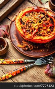 Hokkaido pumpkin baked with minced meat, vegetables and quinoa. Autumn traditional food,squash. Baked pumpkin with minced meat and quinoa
