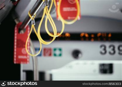 Hold on straps in a bus, commuting, public transport
