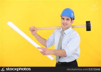 Holding a blueprint and mallet