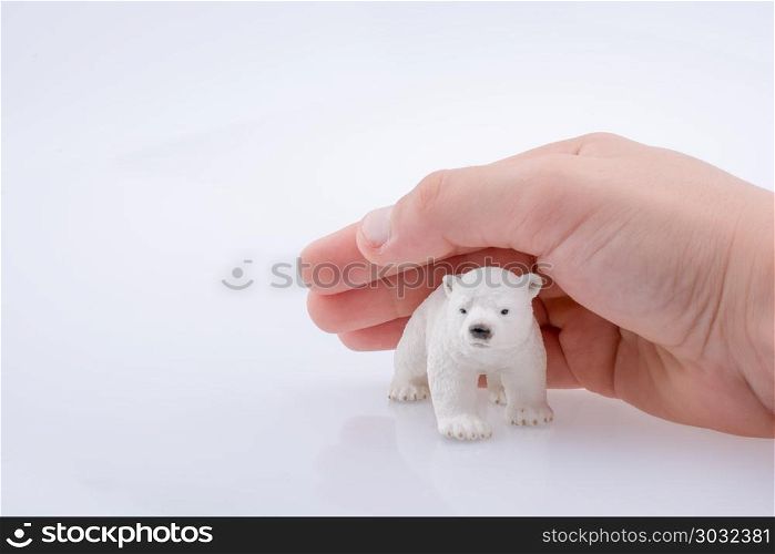 Holding a Polar Bear. Hand holding a Polar bear model