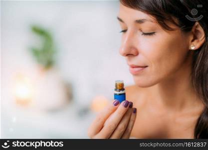 Holding and Smelling Ayurvedic Oil 