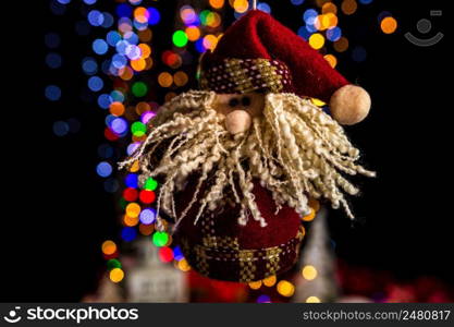 Holding Christmas decoration against bokeh lights background