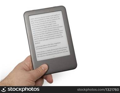 Holding E-book reader in hand. Include clipping path for screen and book with hands. LOREM IPSUM text on e-book screen.
