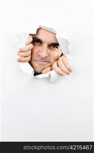 Hole in paper with angry man looking through