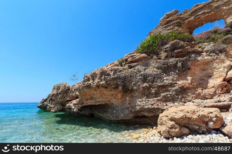 Hole in rock on Drymades beach, Albania. Summer Ionian sea coast view.