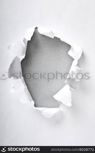 Hole in the paper with torn sides