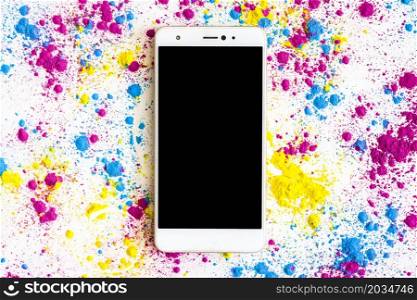 holi color powder around smartphone with black screen display