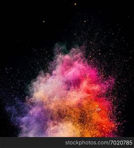 Holi powder exploding on black background. Festival of colors. Copyspace.. Holi powder exploding on black background.