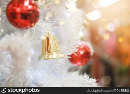 Holiday and Christmas backgrand. Shiny Christmas ball hanging on pine branches.