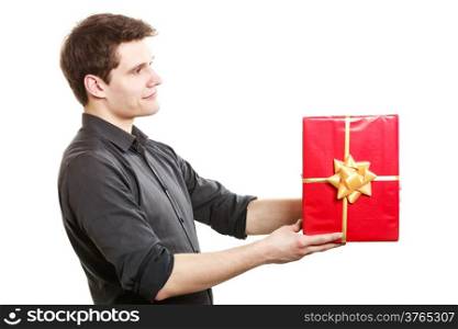 Holiday and special occasion. Young handsome man giving red present gift box with golden ribbon isolated on white. Surprise. Studio shot.