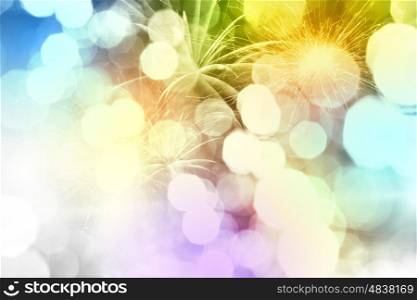 Holiday background. Conceptual image with bokeh lights and fireworks